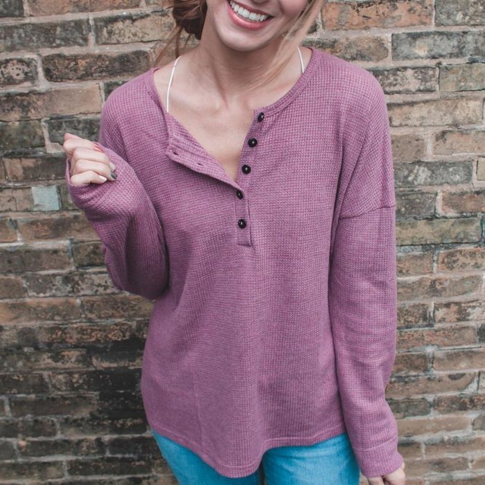 The reviewer dons a light purple Henley for a soft, understated look.