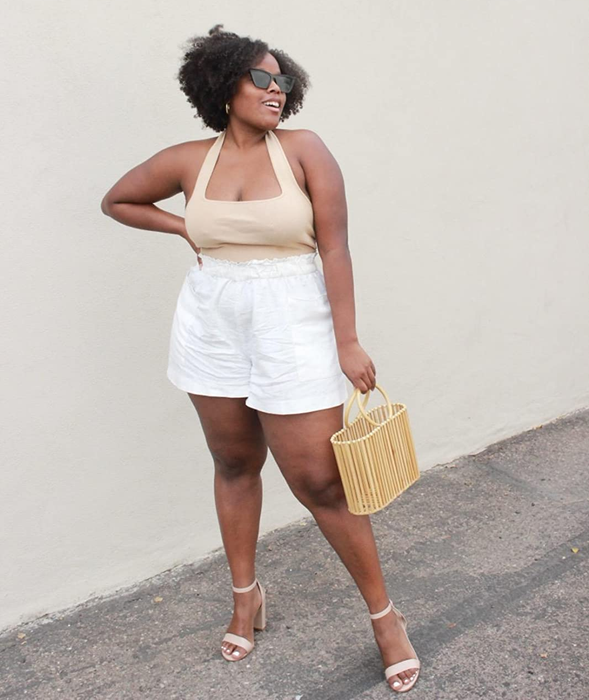 a reviewer modeling the beige halter top