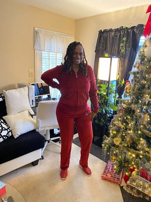 The reviewer is seen sporting a red velour tracksuit.