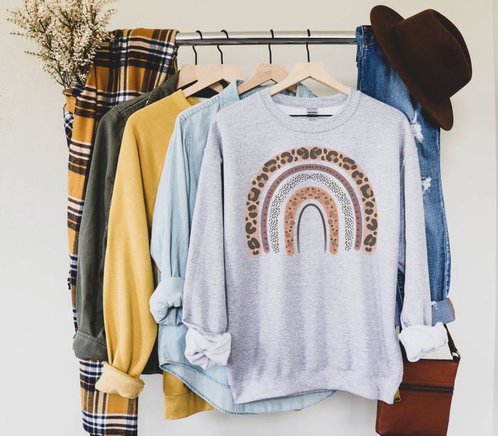 The gray sweater features a leopard rainbow graphic.
