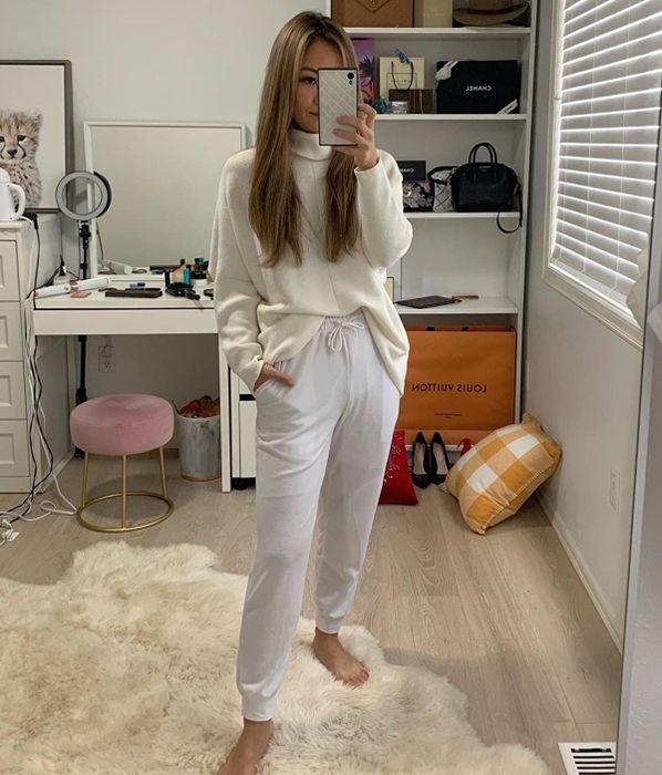Amazon reviewer photographed in a white batwing turtleneck sweater