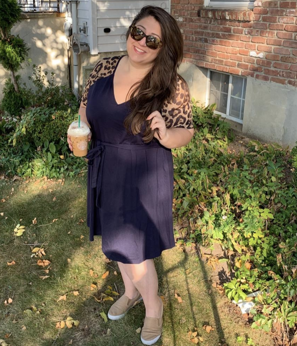 reviewer styling the navy blue dress with leopard print sleeves