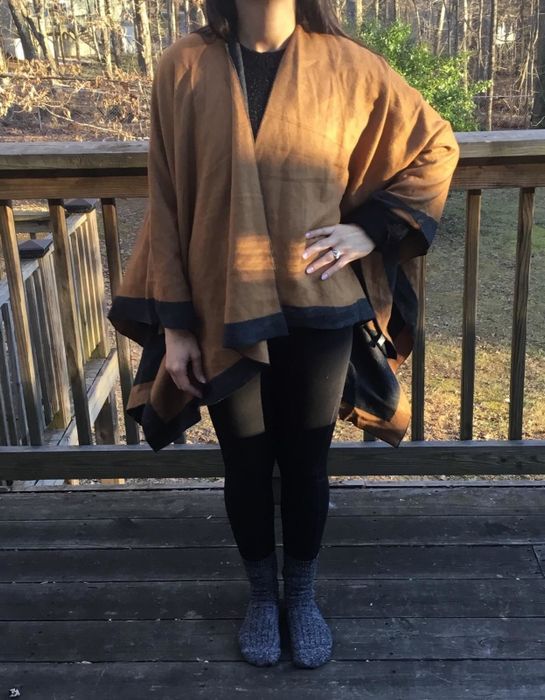 Reviewer showcasing a shawl elegantly draped over their shoulders