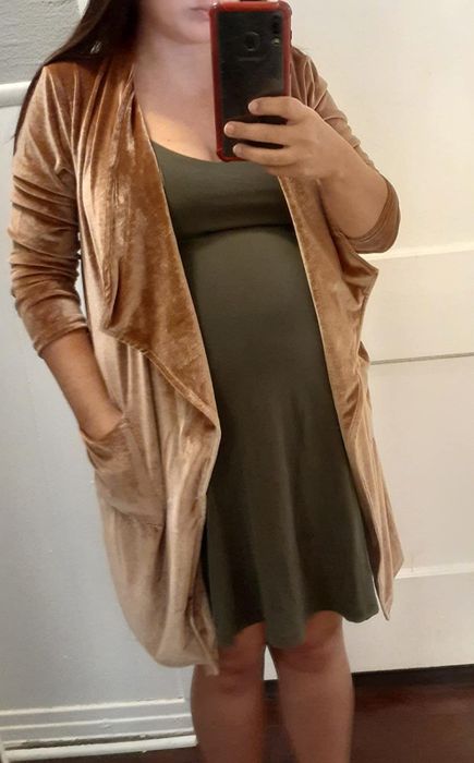 A reviewer styled the tan velvet cardigan over a short green dress for a chic, cozy look.