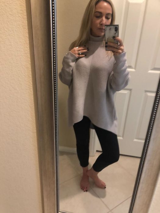 Amazon reviewer wearing a gray batwing-style turtleneck sweater