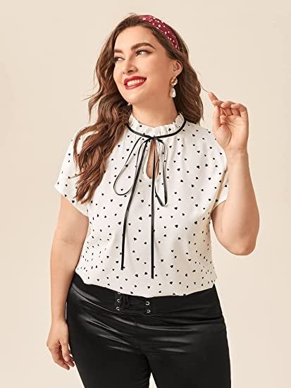 a detailed shot of a model wearing the blouse featuring black hearts