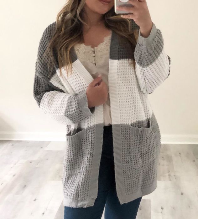 Reviewer modeling the cardigan in a contrasting gray tone