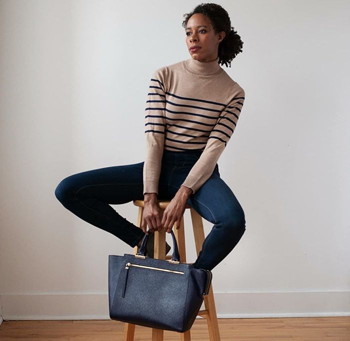 Reviewer showcasing the tan and black striped turtleneck
