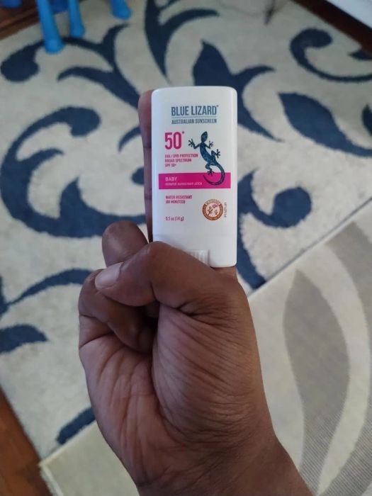 Reviewer's photo of them holding a Blue Lizard Australian Sunscreen Baby 50+ SPF stick, ideal for sensitive skin