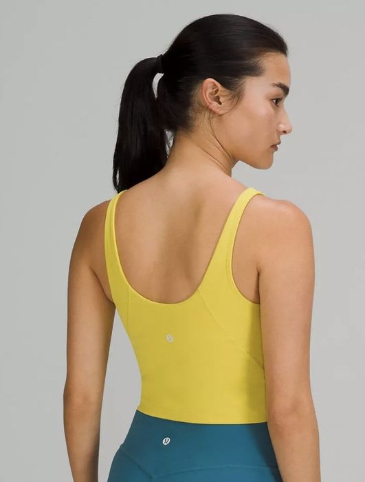 Back view of the model showcasing the yellow tank top from behind.