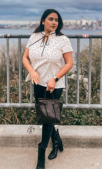a person styled in the same top paired with black jeans and heeled footwear