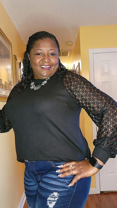 Reviewer wearing a black shirt with sheer lace sleeves