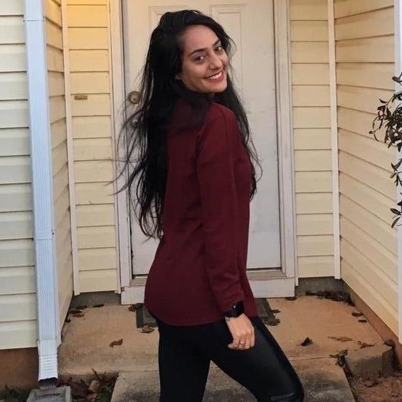 The reviewer shows off the maroon henley from the side.