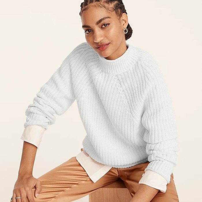 Model showcasing the white sweater