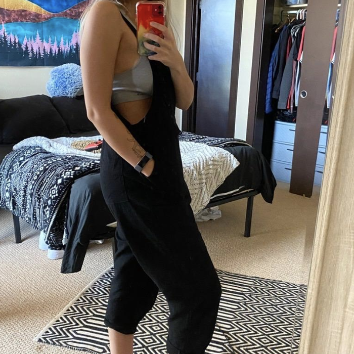 reviewer styled in the jumpsuit with a gray bralette