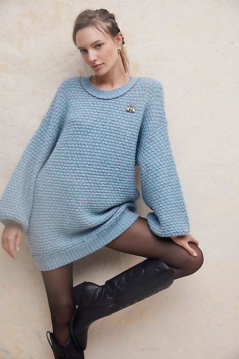 Model wearing a blue cable knit mini sweater dress