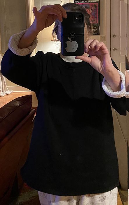 Reviewer wearing a black sherpa-lined crewneck