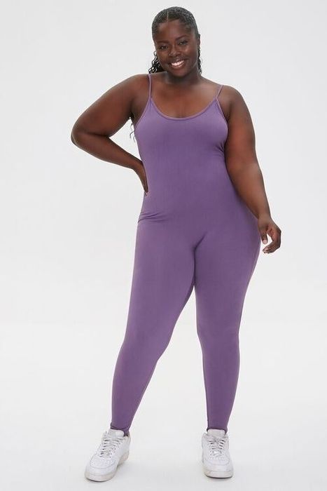 The model is wearing a purple jumpsuit.