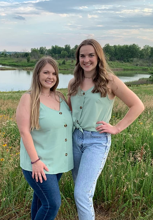 two reviewers showcasing the teal tank top in various sizes