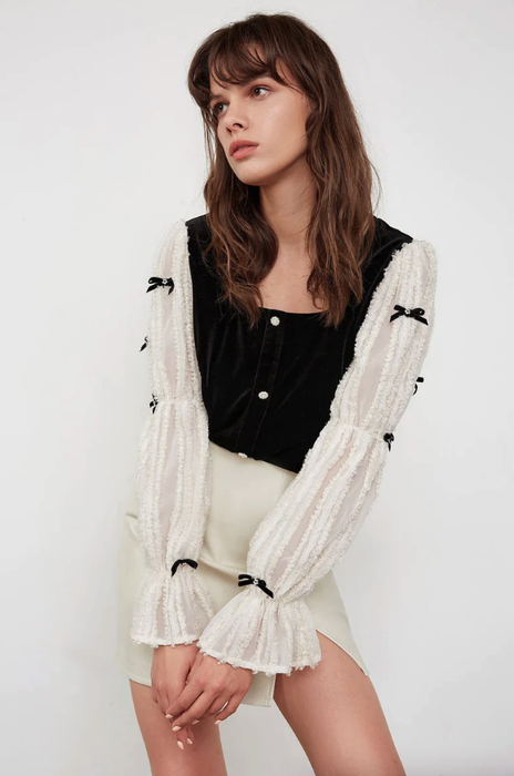 model showcasing the black and white long-sleeve blouse