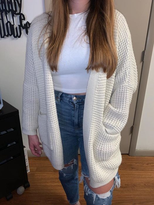 Reviewer posing in the cardigan with one hand casually tucked into a pocket