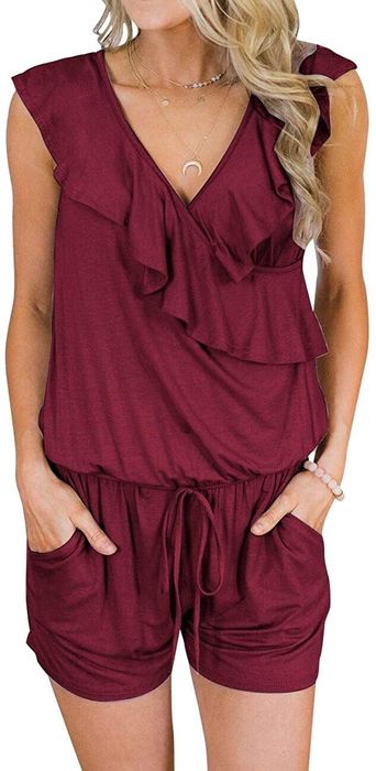 A model showcasing the red romper with hands tucked into the pockets