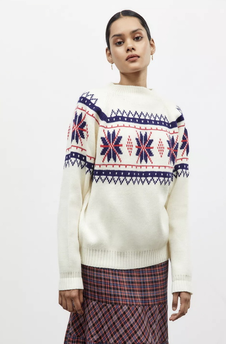Stylist pairs the heritage-inspired sweater with a tailored skirt for transitional elegance