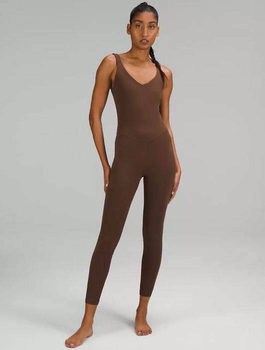 model wearing a dark brown sleeveless romper with pants