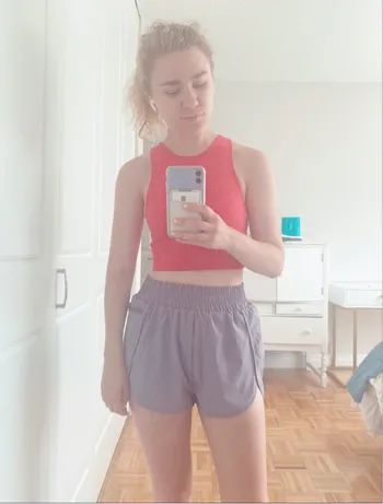 A Mytour editor wearing high-waisted purple elastic shorts