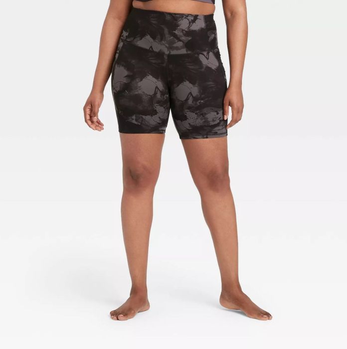A model wearing the black and gray acid wash bike shorts