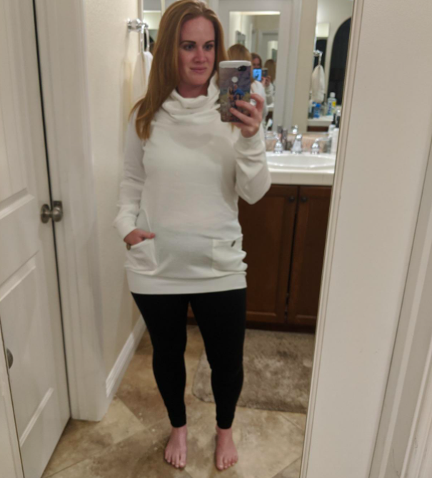 The snow-white knit sweater showcased in a monochromatic winter look