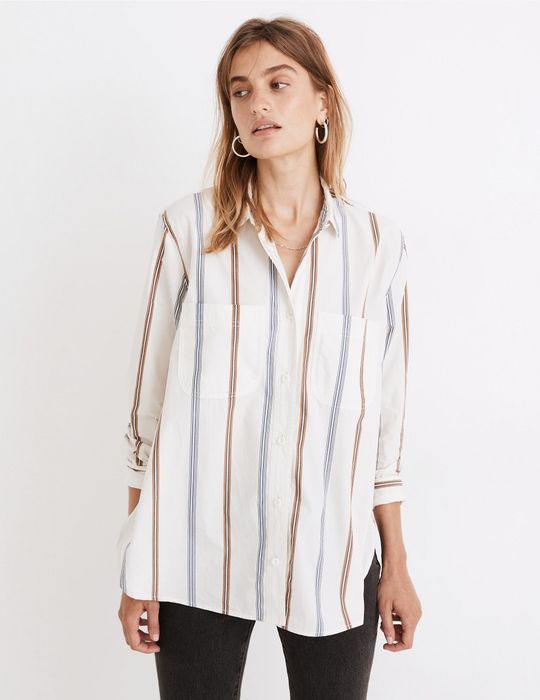 Stylist showcases the nautical-inspired striped shirt paired with tailored black trousers