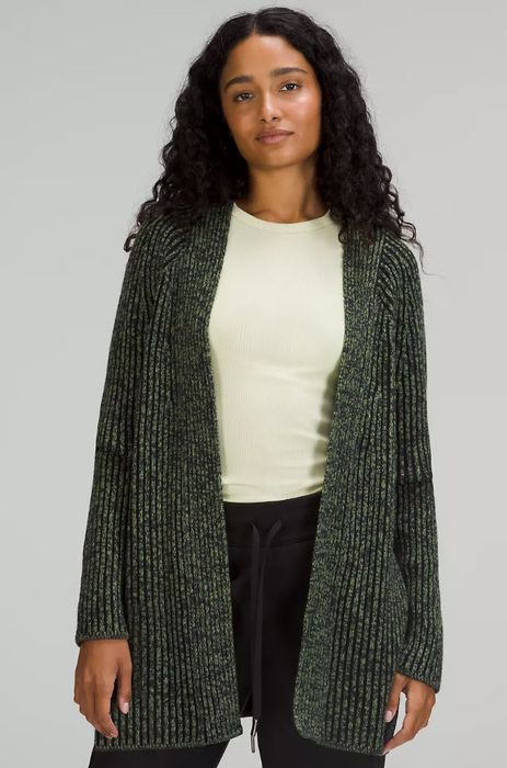 model sporting an oversized olive knit cardigan