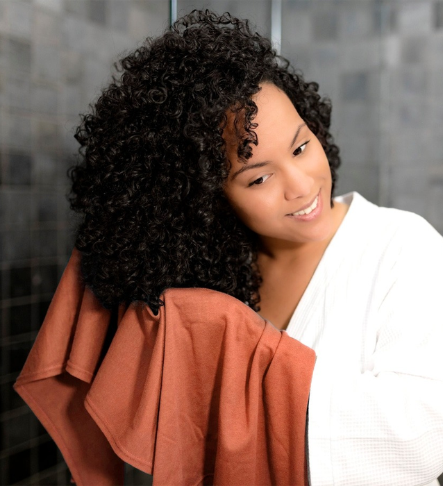Model using the same towel to scrunch their curls