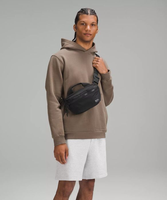 model wearing the black fanny pack across their chest