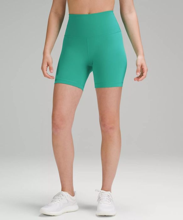 A model wearing green, medium-length shorts.