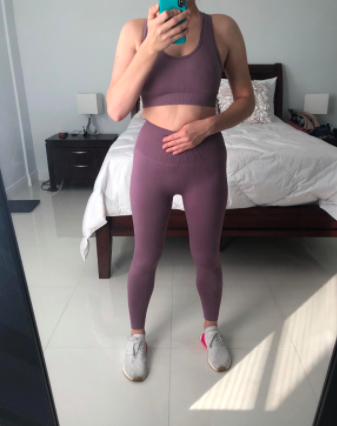 Reviewer demonstrates the front view of the same set in a mirror while wearing sneakers
