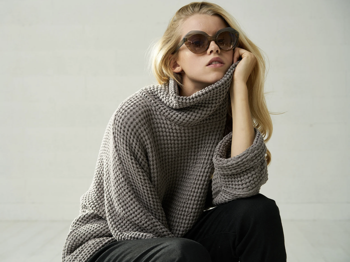 Editorial-style presentation of the heather gray knit masterpiece