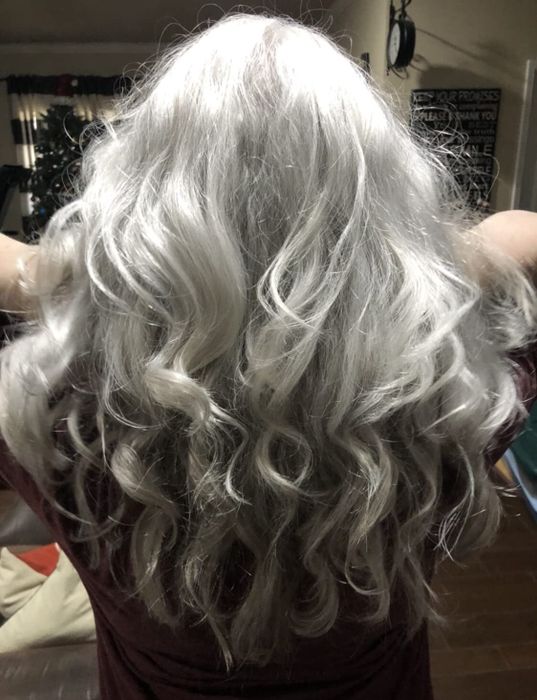 Reviewer with silver hair showcasing their smooth, silky locks