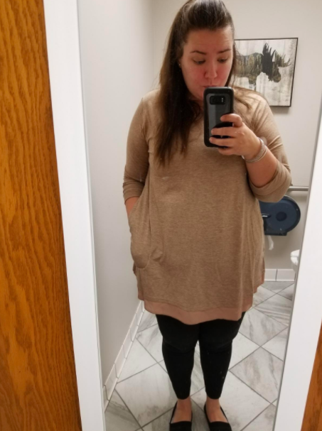 A style enthusiast styled in the taupe-hued blouse
