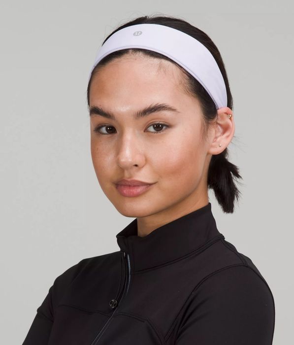 A model wearing a pastel blue headband.