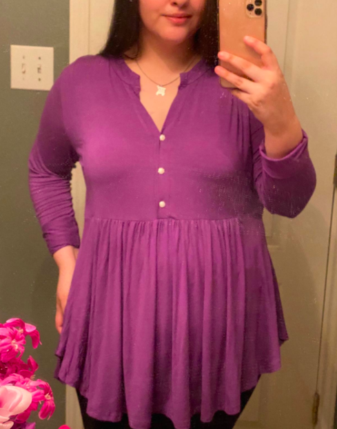 A fashion influencer styled in the violet shirt