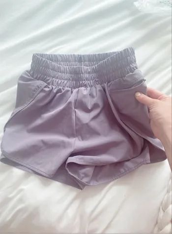The shorts with the editor showcasing a small zippered side pocket