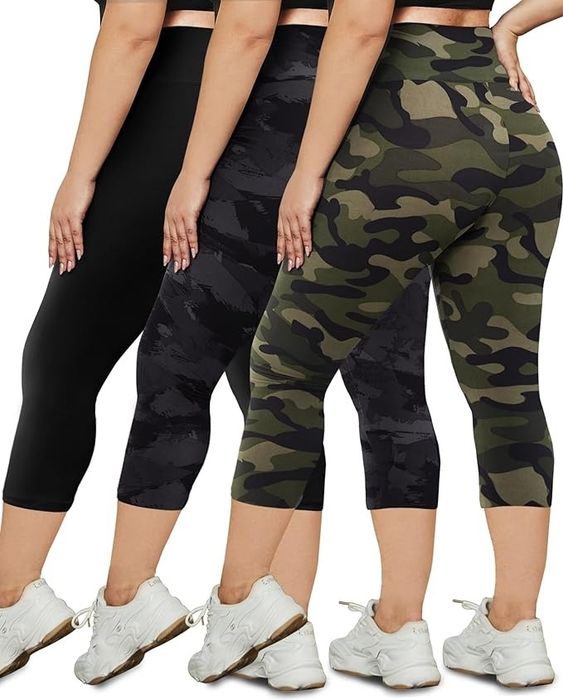 Three individuals standing side by side, each wearing uniquely patterned leggings and white sneakers