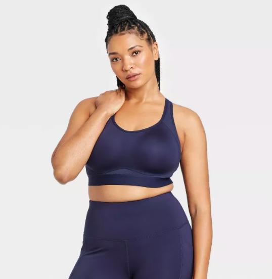 Model showcases a navy blue convertible sports bra paired with matching leggings