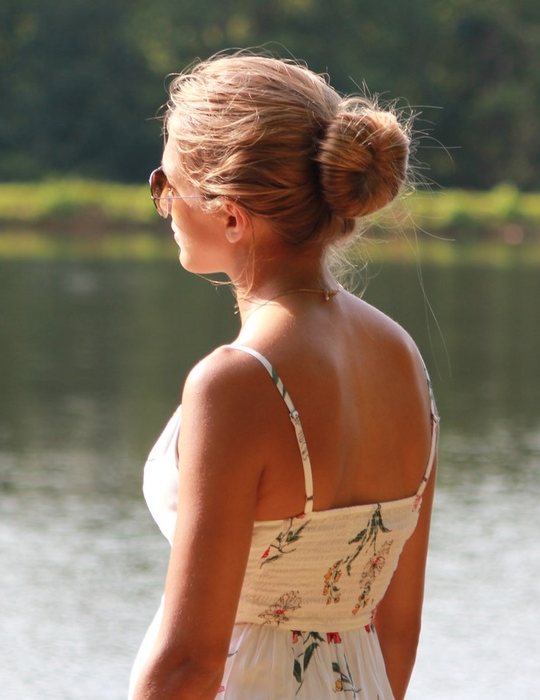 Model showcasing their hair styled in a bun