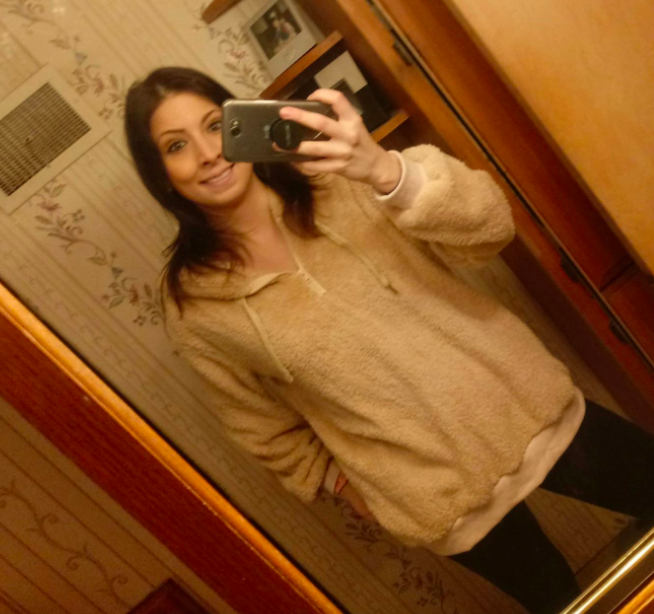 The khaki Sherpa hoodie showcased in a casual ensemble