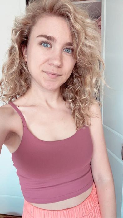 A Mytour editor wearing a pink strappy crop top