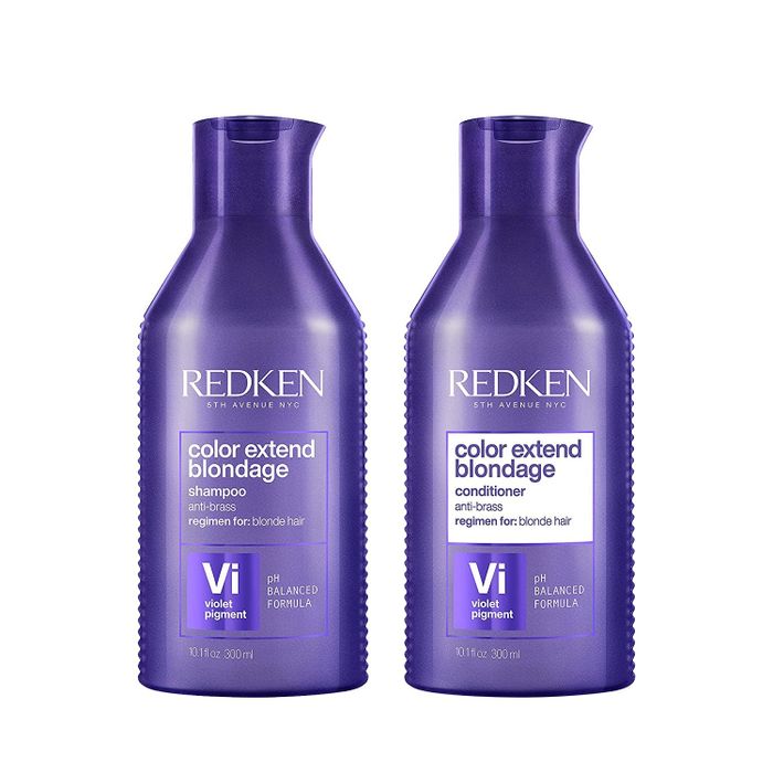 Purple shampoo and conditioner bottles displayed on a white background