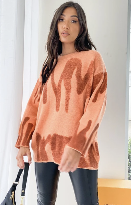 Editorial street style featuring tangerine knit paired with metallic leggings